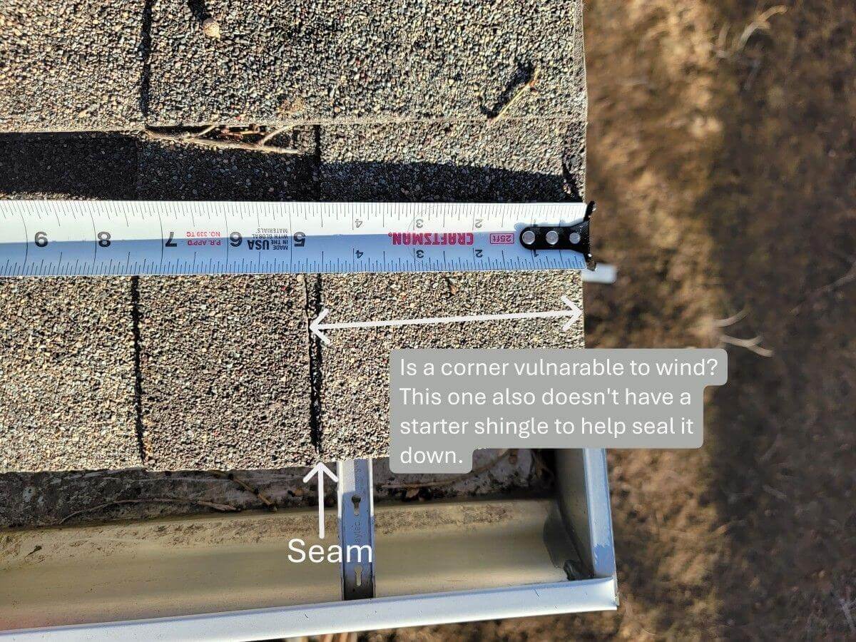 A tape measure at a rake edge showing no starter shingle to seal the edge.