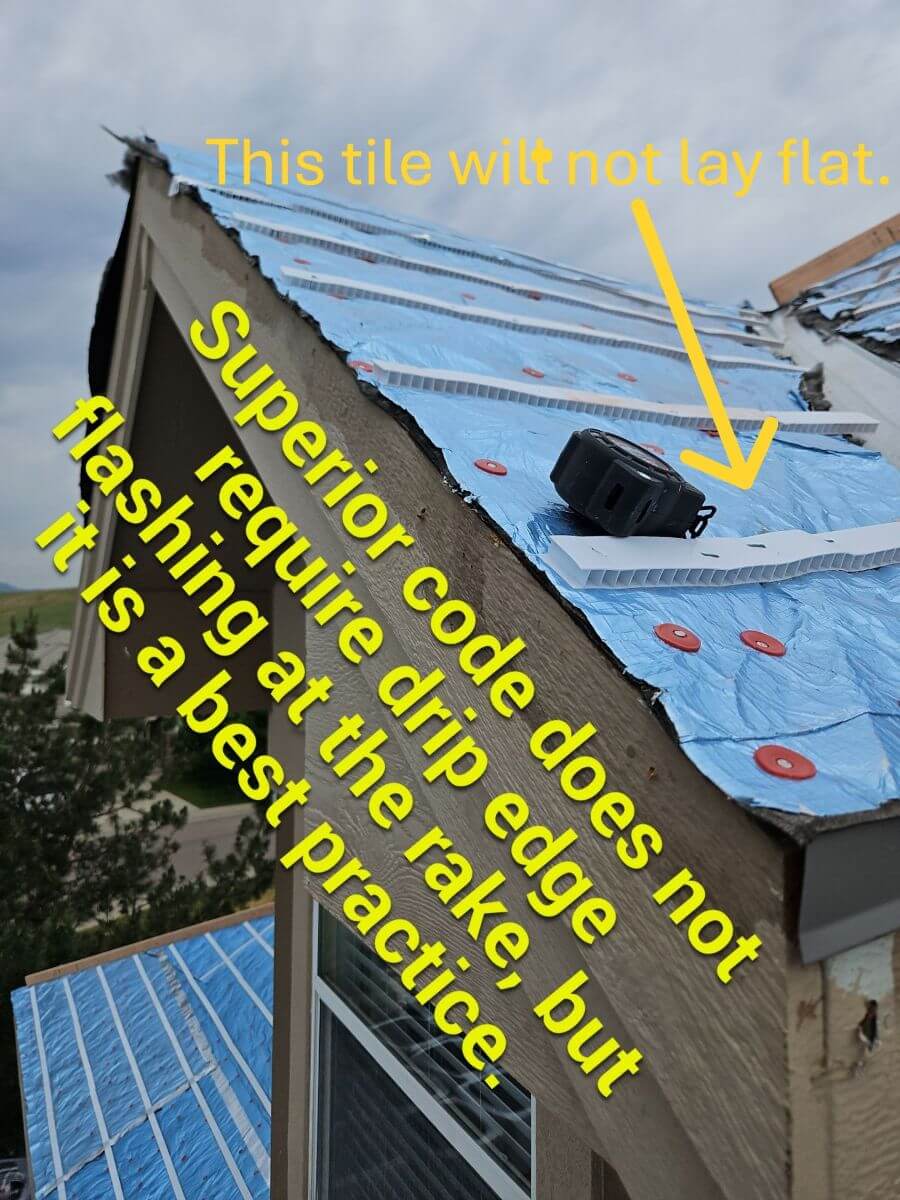 A rake edge of a tile roof without drip edge flashing and creased battens causing the tile to not lay flat.