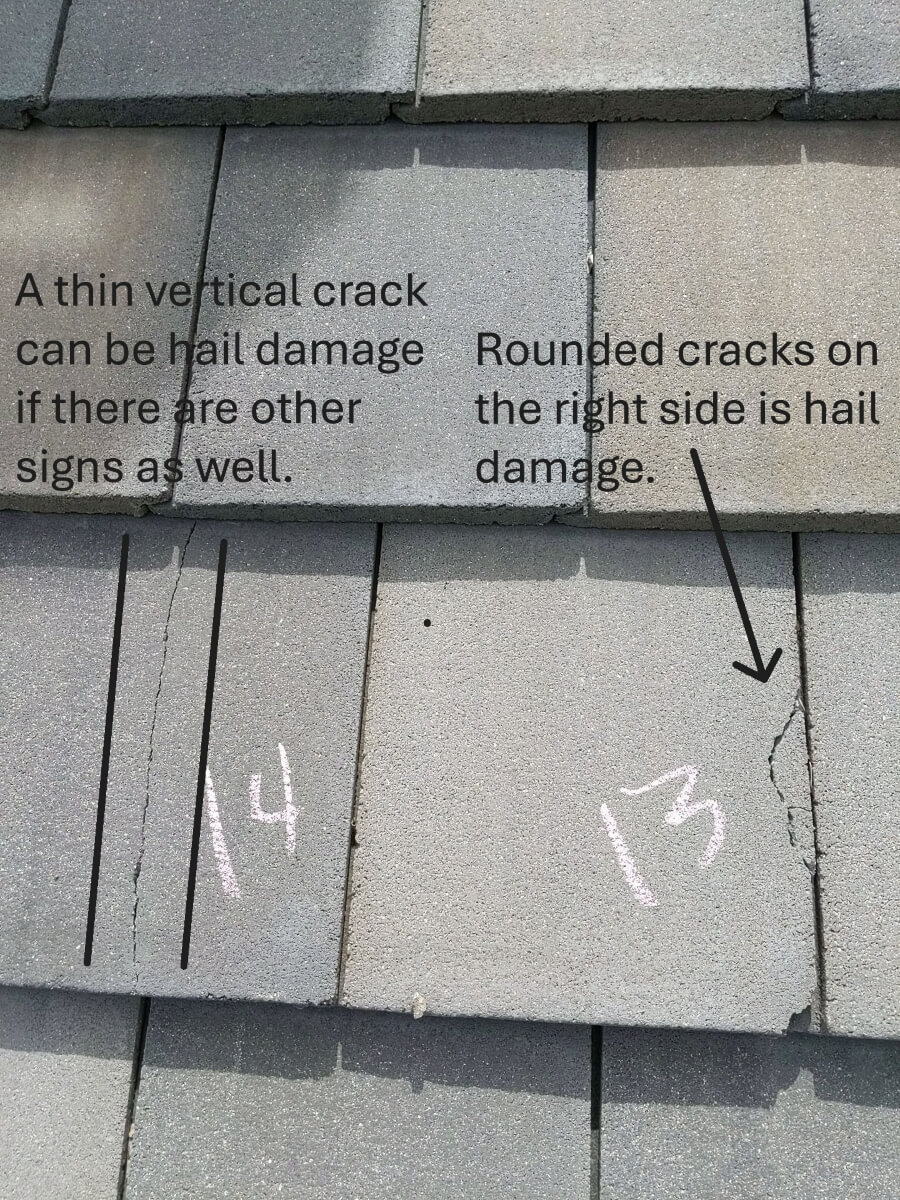 Arched, rounded hail damage crack on the edge of a concrete roof tile.