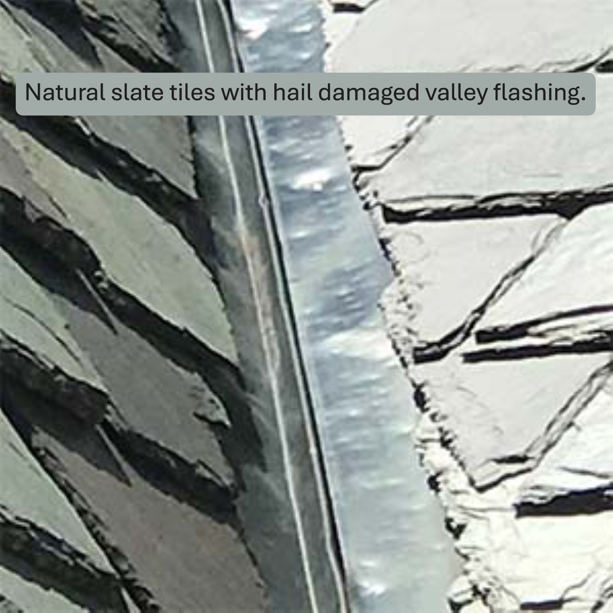 Hail damage dents on the metal valley flashing of a natural slate roof.