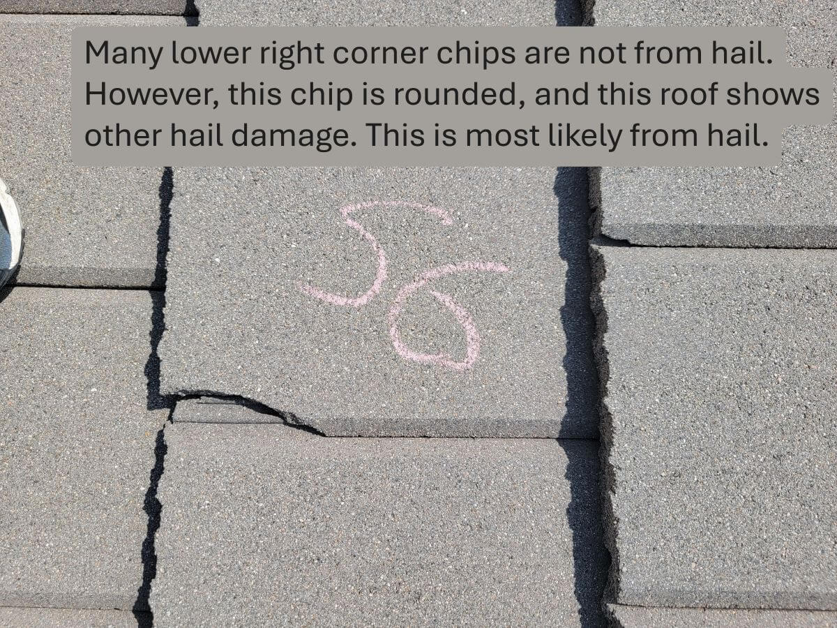 Rounded cracks on the corner of a concrete tile indicating hail damage.